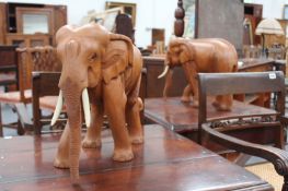 A PAIR OF CARVED HARDWOOD ELEPHANTS