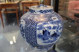 A CHINESE BLUE AND WHITE COVERED VASE WITH FIGURAL PANELS
