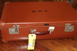 A BROWN LEATHER SUITCASE