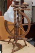 AN ANTIQUE SPINNING WHEEL AND A SEWING MACHINE