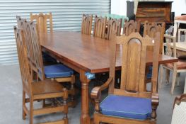 AN IMPRESSIVE BESPOKE OAK REFECTORY TABLE TOGETHER WITH A SET OF TWELVE PANEL BACK AND SEAT DINING