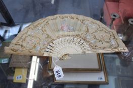 A HAND DECORATED FAN