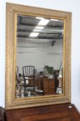 A LARGE GILT FRAMED MIRROR