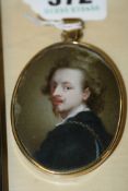 A 19TH.C.OVAL MINIATURE PORTRAIT OF A GENTLEMAN IN 17TH.C.DRESS. YELLOW METAL MOUNTS. WATERCOLOUR.