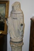 A GOTHIC STYLE SCULPTURE OF A HOODED MONK