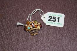 A 9CT GOLD GEM SET BASKET OF FLOWERS BROOCH.