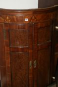 A REGENCY MAHOGANY BOW FRONT CORNER CABINET