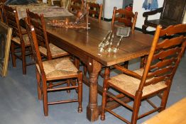 A BESPOKE OAK REFECTORY TABLE AND TEN RUSH SEAT LADDER BACK CHAIRS