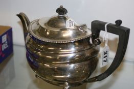 A HALLMARKED SILVER TEA POT