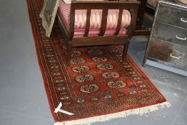 AN ORIENTAL RUNNER OF BOKHARA DESIGN. 335 X 102 CMS