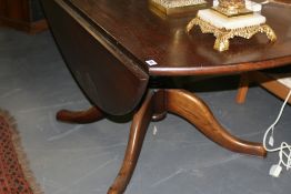 A LARGE OAK DROP LEAF TABLE