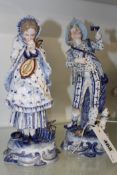 A PAIR OF CONTINENTAL PORCELAIN FIGURES OF A BOY AND GIRL WITH MUSICAL INSTRUMENTS, 24CM HIGH