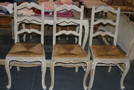 A SET OF SIX FRENCH STYLE PAINTED RUSH SEAT DINING CHAIRS