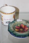 A MOORCROFT ASHTRAY, A COMMEMORATIVE CUP AND A WILLOW PATTERN SAUCER