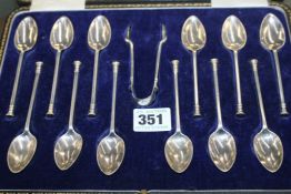 A SET OF TWELVE SILVER TEA SPOONS.