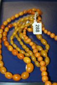 A LARGE STRING OF GRADUATED AMBER  BEADS TOGETHER WITH TWO OTHER BEAD NECKLACES