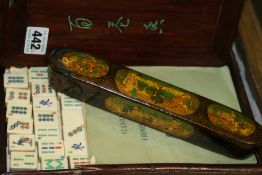 AN OLD CHINESE HARDWOOD CASED MAHJONG SET AND A PERSIAN LACQUER WRITING CASE WITH FIGURAL DECORATION