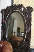AN ELABORATELY CARVED ANTIQUE ORIENTAL CHEVAL MIRROR