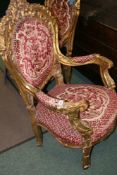 A PAIR OF CARVED GILT FRAMED OPEN ARMCHAIRS