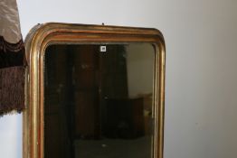 A LARGE GILT FRAMED OVERMANTLE MIRROR