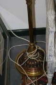 A VICTORIAN BRASS AND COPPER STANDARD LAMP TOGETHER WITH AN EBONISED TORCHERE
