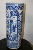 AN ANTIQUE CHINESE BLUE AND WHITE STICK/UMBRELLA STAND, ALTERNATING PANELS OF FIGURES AND FOLIAGE.