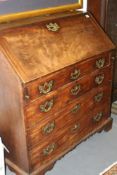 A GEO.III.MAHOGANY BUREAU WITH SHAPED STEPPED FITTED INTERIOR