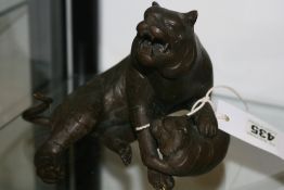 AN ORIENTAL BRONZE OF A SNARLING CAT WITH YOUNG.