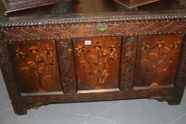 AN 18TH.C.OAK COFFER WITH CARVED AND INLAID DECORATION