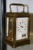 A BRASS CASED STRIKING CARRIAGE CLOCK.