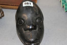 A TRIBAL POLISHED STONE WEIGHT IN THE FORM OF A HEAD