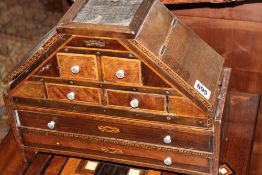 A GEORGIAN ROSEWOOD AND INLAID MULTI DRAWER TABLE CABINET