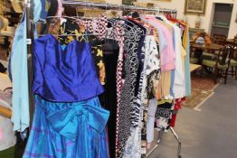 A RACK OF LADIES SUMMER WARE AND PARTY DRESSES.