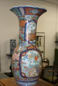 A LARGE ANTIQUE JAPANESE IMARI BALUSTER FORM VASE WITH OVERALL FLORAL DECORATION AND PANELS OF