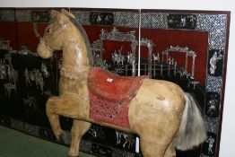A POLYCHROME DECORATED CARVED WOODEN HORSE
