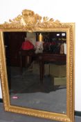 A LARGE GILT FRAMED MIRROR