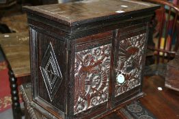 A 19TH.C.OAK SPICE CABINET, THE DOORS WITH CARVED DRAGON DECORATION