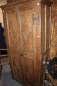 AN OAK PANEL DOOR CUPBOARD