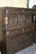 A 17TH.C.CARVED OAK COURT CUPBOARD