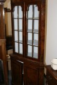 A BURR WALNUT FLOOR STANDING CORNER CABINET