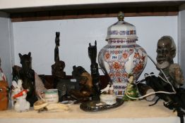A BOAR`S TUSK CORKSCREW, VARIOUS ETHNIC CARVINGS, TABLE LAMP,ETC
