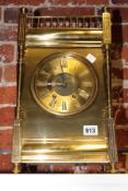 AN ALL BRASS BRACKET CLOCK OF CARRIAGE FORM WITH GALLERIED TOP.