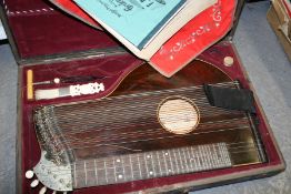 A ZITHER BY GEORG TIEFENBRUNNER, MUNCHEN CONTAINED IN ITS RED VELVET LINED CASE WITH VARIOUS