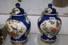 A PAIR OF ORIENTAL BALUSTER VASES AND COVERS.