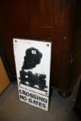 A CAST IRON TRAIN CROSSING SIGN