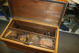 A LARGE ANTIQUE PINE TOOL CHEST AND A SET OF MOULDING PLANES