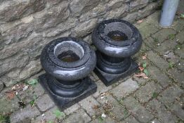 A PAIR OF CARVED STONE URNS