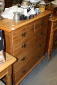 AN EDWARDIAN CHEST OF DRAWERS