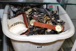 A LARGE TUB OF ASSORTED LADY`S AND GENTLEMAN`S DRESS WATCHES.