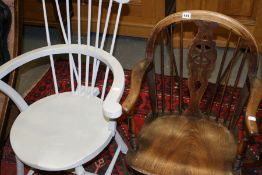 A WHEEL BACK ARMCHAIR AND A PAINTED STICK BACK CHAIR